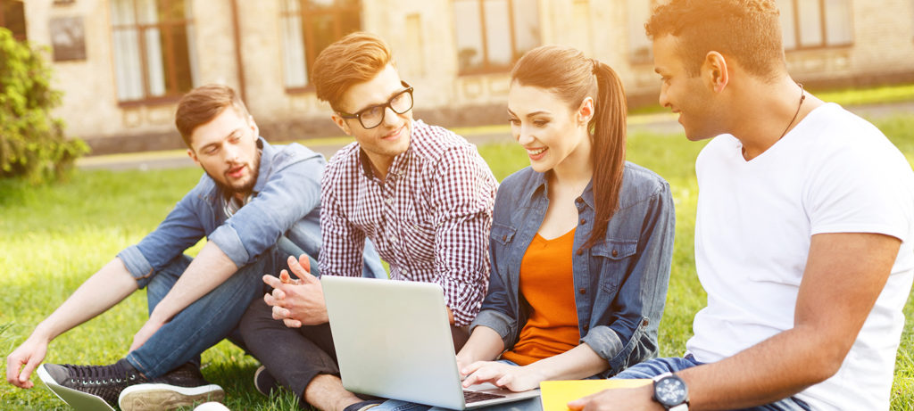 Happy young students are chatting in campus