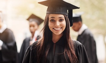 College graduate smiling and happy for the education she was able to receive because of the Coverdell Education Savings Account