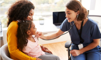 Mother and daughter at the doctors office getting heartbeat checked by woman doctor